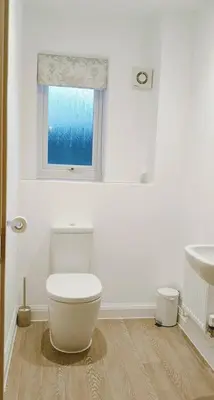 a white bathroom with a toilet and a sink at Calm Private Room Near Truro - Short Stays Welcome in Kea