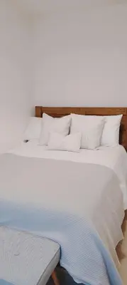 a large bed with white sheets and pillows at Calm Private Room Near Truro - Short Stays Welcome in Kea