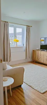 a living room with a couch and a window at Calm Private Room Near Truro - Short Stays Welcome in Kea
