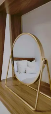 a mirror on a shelf with a bed in a room at Calm Private Room Near Truro - Short Stays Welcome in Kea