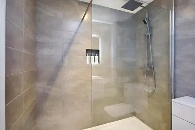 a bathroom with a shower with a glass door at 2022 Two Bed Stylish House Near Beach in Hayle