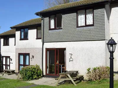 a house with a picnic table in front of it at Bolthole in Hayle