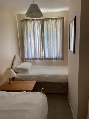 a bedroom with two beds and a window at Bolthole in Hayle