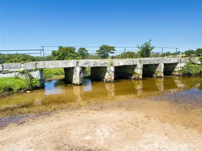 an old stone bridge over a river at Providence House St Breward near coastbeaches in Saint Breward