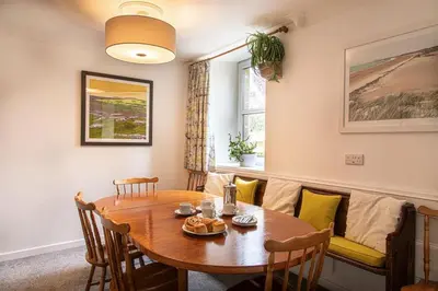 a dining room with a table and a couch at Providence House St Breward near coastbeaches in Saint Breward