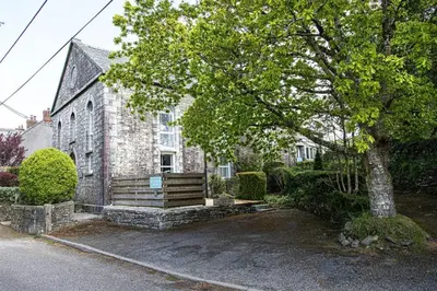 a house with a bench in front of a building at Providence House St Breward near coastbeaches in Saint Breward