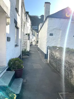 an alley with buildings and a water fountain at Warren Cottage in the pretty village of Polperro in Polperro