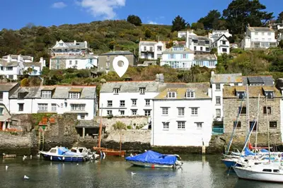 a group of boats docked in a harbor with houses at Warren Cottage in the pretty village of Polperro in Polperro