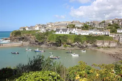a group of boats in a body of water at White Pebble Cottage popular village - Port Isaac in Port Isaac