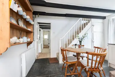 a dining room with a table and chairs at White Pebble Cottage popular village - Port Isaac in Port Isaac