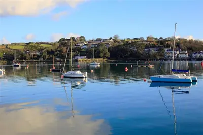 a group of boats sitting in a body of water at Lilliput Mabe far views of the countryside in Budock Water