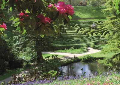 a garden with a maze and a pond at Lilliput Mabe far views of the countryside in Budock Water