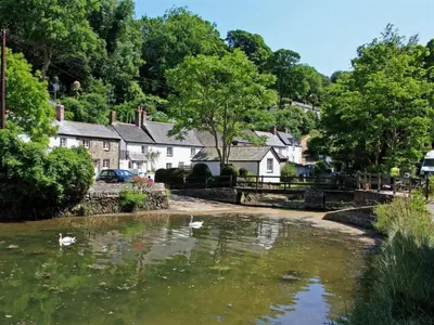 a village with a river with swans in it at Lilliput Mabe far views of the countryside in Budock Water