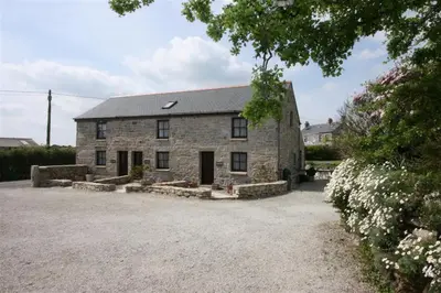 an old stone house with a gravel driveway at Lilliput Mabe far views of the countryside in Budock Water