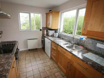 a kitchen with a sink and a dishwasher at Pentref St Just in Roseland with beautiful views in Saint Just in Roseland