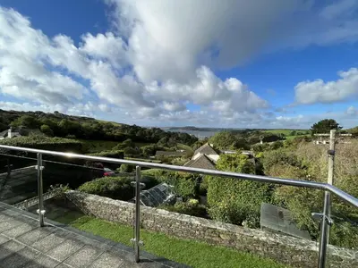 a view of the countryside from the balcony of a house at Pentref St Just in Roseland with beautiful views in Saint Just in Roseland