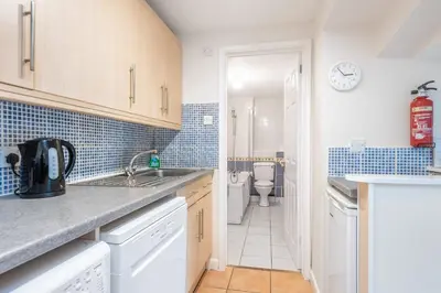 a kitchen with a sink and a toilet at Atlantic View Mawgan Porth with sea views in Saint Mawgan