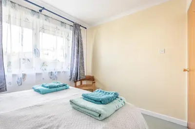 a bedroom with a bed with two pillows on it at Shellseekers lovely views across Port Isaac in Port Isaac