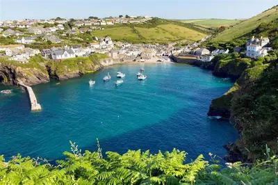 a group of boats in a body of water at Shellseekers lovely views across Port Isaac in Port Isaac