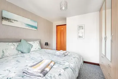 a bedroom with a bed with towels on it at Giggles in the heart of bustling town Wadebridge in Wadebridge