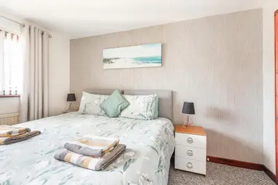 a bedroom with a bed with pillows on it at Giggles in the heart of bustling town Wadebridge in Wadebridge