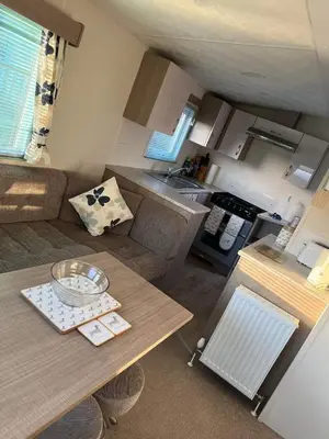 a living room with a couch and a table at Static Caravan 9 in Lansallos