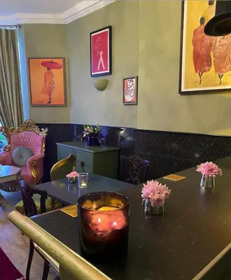 a restaurant with two tables with flowers on it at The White House Hotel in Newquay