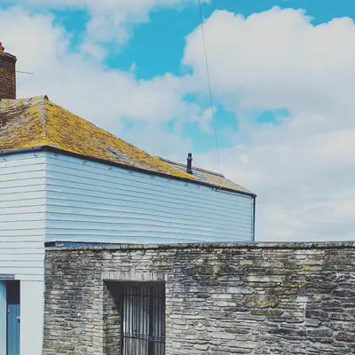 a brick building with a kite flying in the sky at The White House Hotel in Newquay
