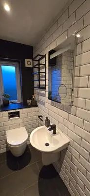 a white bathroom with a toilet and a sink at Hove Too in Saint Day
