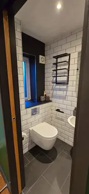 a bathroom with a white toilet and a sink at Hove Too in Saint Day