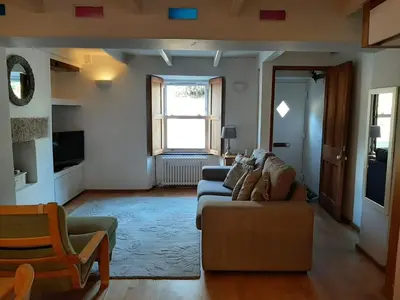 a living room with a couch and a chair at 2 Umfula Place in St Ives
