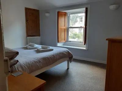 a bedroom with a bed and a window at 2 Umfula Place in St Ives