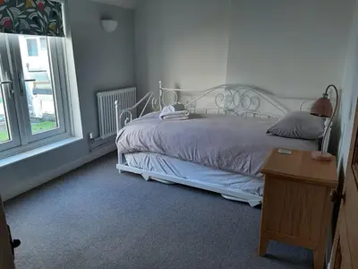 a bedroom with a white bed and a window at 2 Umfula Place in St Ives
