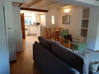 a living room with a couch and a table with chairs at 2 Umfula Place in St Ives