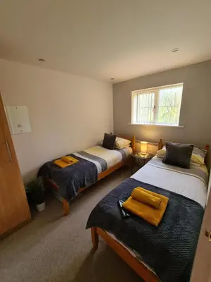 a bedroom with two beds and a window at Inny Glade in Davidstow