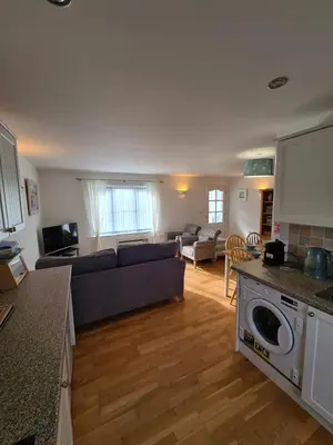a kitchen and living room with a couch and a table at Inny Glade in Davidstow
