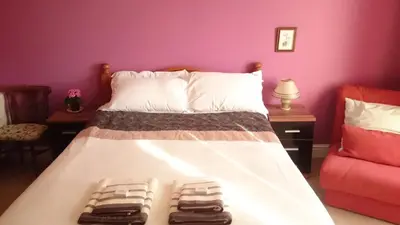 a bedroom with a bed with two towels on it at Bankside Bed & Breakfast in St Austell