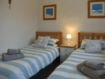 two beds sitting next to each other in a bedroom at Ash in Scorrier