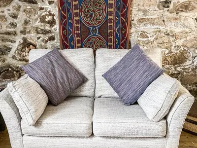 two pillows sitting on a couch in a room at Driftwood in St Ives