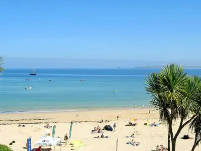 a beach with a lot of people and the ocean at Driftwood in St Ives
