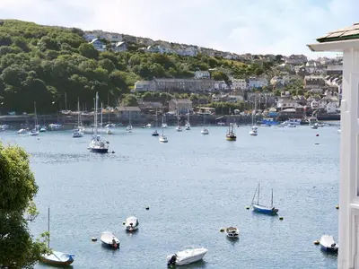 a group of boats in a large body of water at The Pool House in Tywardreath