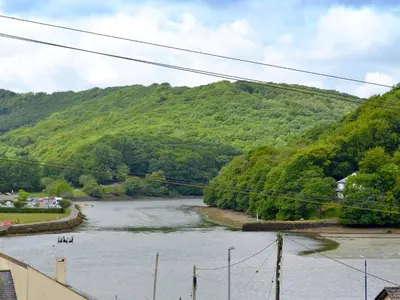 a river with a group of people on it at Watersmeet in Looe