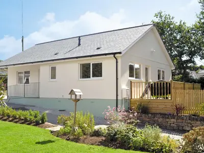 a small white house with a fence at Tegen in Tywardreath