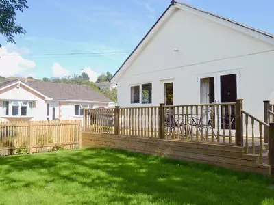 a wooden deck in front of a house at Tegen in Tywardreath