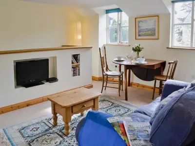 a living room with a couch and a tv and a table at Tucked Away in Linkinhorne