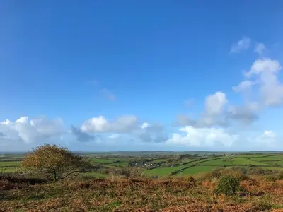 a view of a green field from a hill at The Roost in Saint Breward