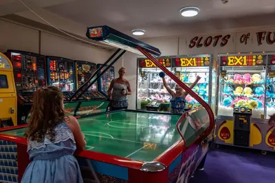 a group of children playing a game in a arcade at Newquay Bay Holiday Resort in Newquay