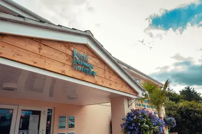 a building with a sign on the side of it at Newquay Bay Holiday Resort in Newquay