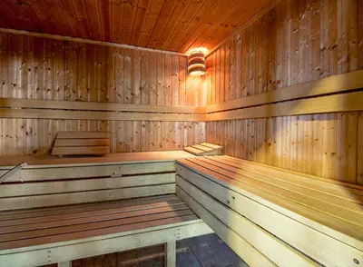 a wooden sauna with two wooden benches in it at Newquay Bay Holiday Resort in Newquay
