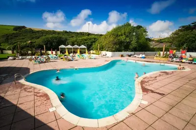 a large swimming pool with people in it at Newquay Bay Holiday Resort in Newquay